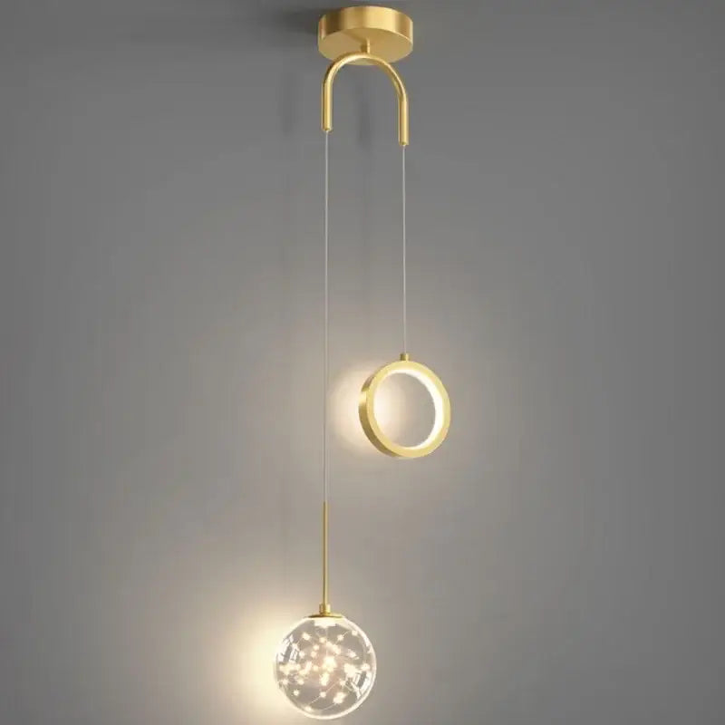 Modern gold ring led pendant light featuring a gold-toned circular ring and crystal glass globe with fairy lights decorbites gold ring