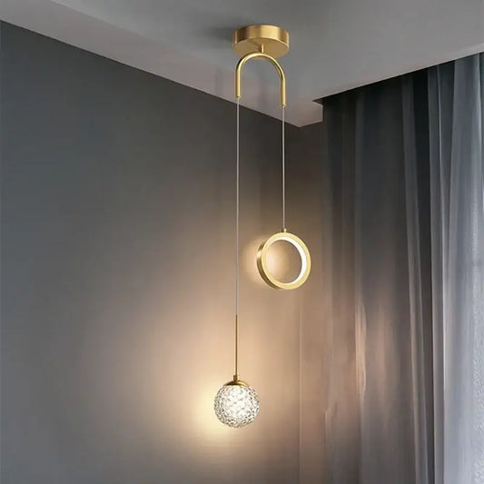 Modern gold ring led pendant light featuring a gold-toned curved arm and crystal globe for dining room decorbites gold ring