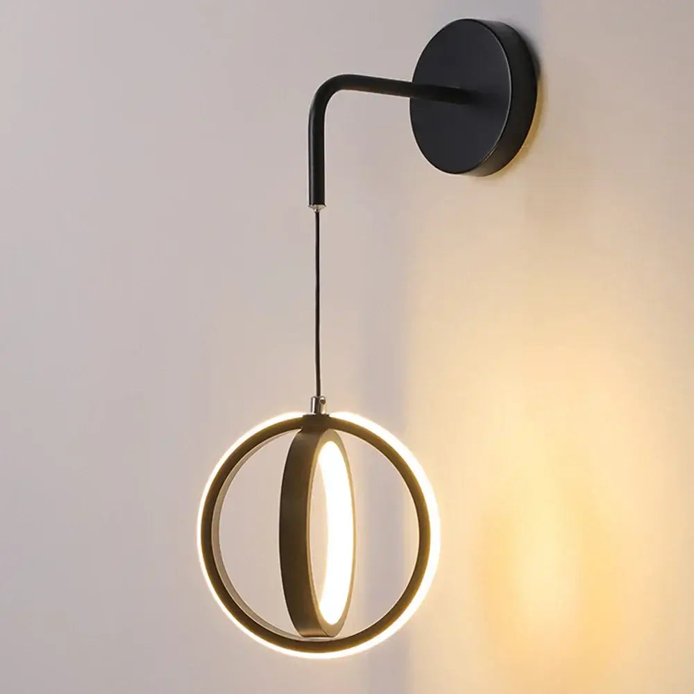 Modern black wall lamp with sleek curved arm and illuminated circular ring led wall lamp for bedroom and living room