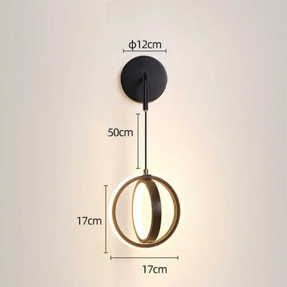 Modern gold ring led wall lamp with black circular frame and two gold-toned rings illuminating a sleek led wall light