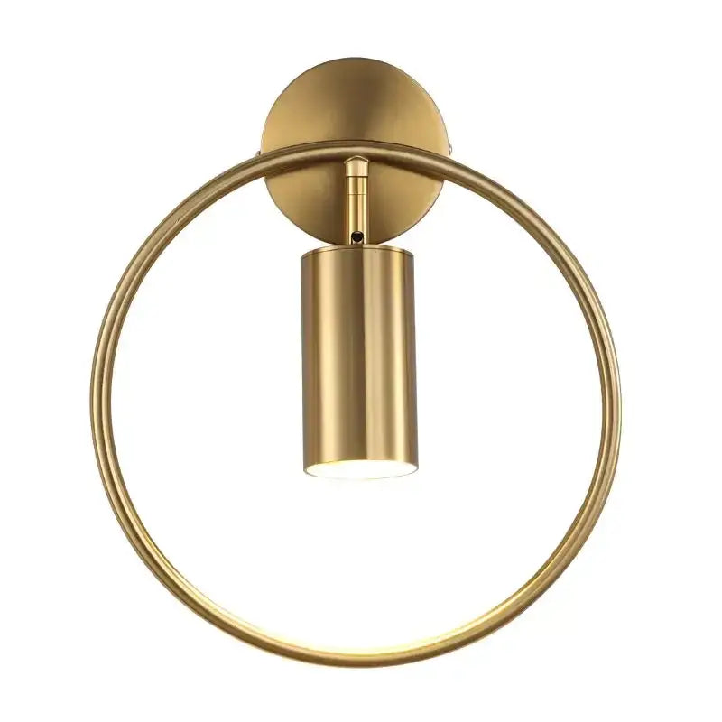Modern gold ring led wall sconce light featuring a gold-toned circular frame and cylindrical sconce light fixture for bedroom use