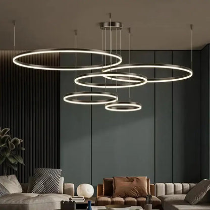 Modern gold ring pendant ceiling lamp with concentric circular rings and soft white led glow for dining room decorbites gold ring