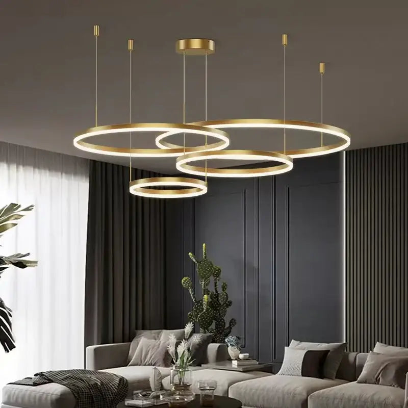 Modern gold ring pendant ceiling lamp with multiple overlapping rings and illuminated edges for dining room decorbites gold ring