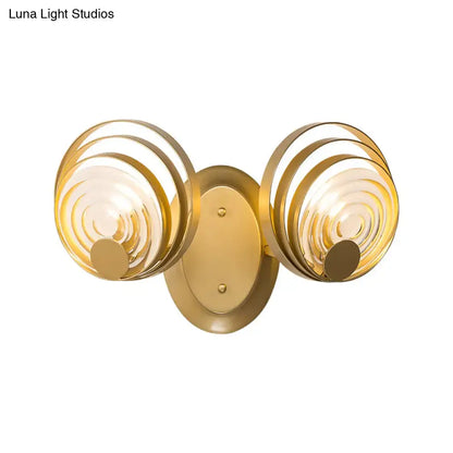 Modern gold ripple glass wall light fixture with two circular concentric glass shades for living room use