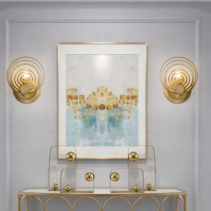 Modern gold ripple glass wall light fixture featuring gold-toned concentric circles for living room use