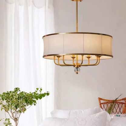Modern gold rod led chandelier with gold-toned frame, cylindrical off-white fabric shade, and crystal accent for living room decorbites gold rod
