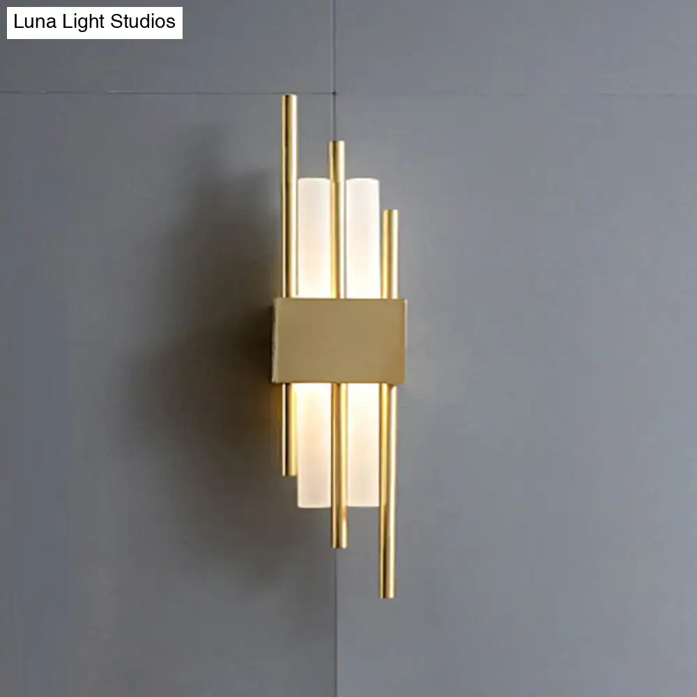 Modern gold-toned wall light with frosted glass cylinders and rectangular metal base for 110v-120v use