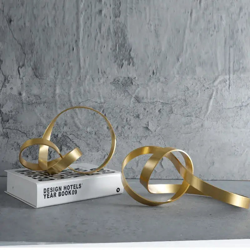 Modern gold rope knot metal sculpture with intertwined flowing loops for home decor by decorbites gold rope