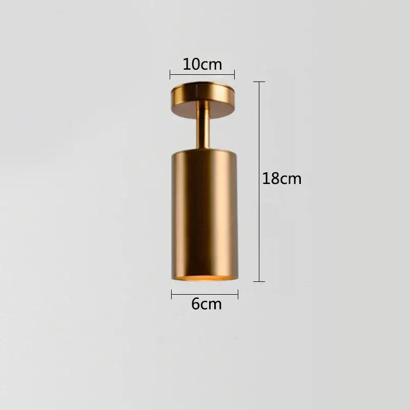 A sleek cylindrical gold rotating led spotlight with matte metallic finish and dimensional markings for dining rooms