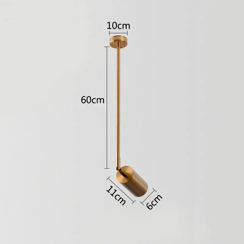 A sleek modern gold brass pendant light with cylindrical shade and slender stem featuring rotating led spotlights