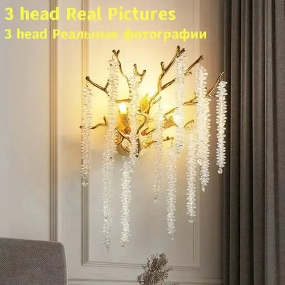 Modern gold round crystal branches chandelier features a gold-toned branch wall sconce with cascading clear crystals