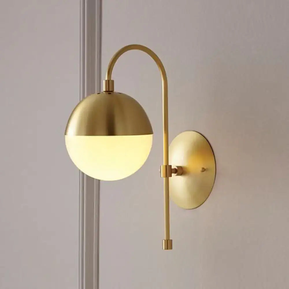 Modern gold round wall lamp with opal glass featuring a gold-toned curved arm round wall lamp for bedroom use