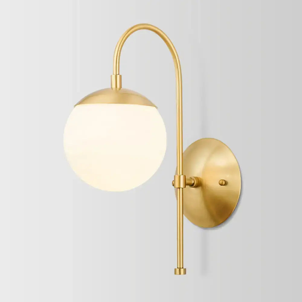 Modern gold round wall lamp with gold-toned curved arm and opal frosted glass shade for bedroom wall lamp