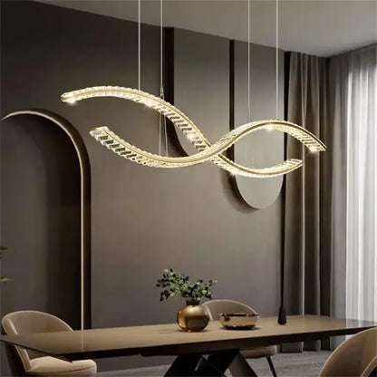 A modern gold-toned decorbites crystal led pendant with sleek intertwined s-shaped design for dining room lighting
