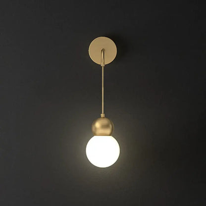 Modern gold sconce light wall lamp featuring a gold-toned spherical pendant with milky glass and minimalist fixture