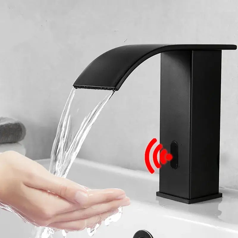 Black matte basin faucet with sleek curved spout and decorbites gold sensor waterfall technology for bathroom use