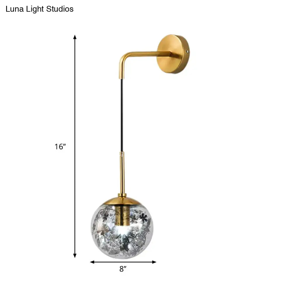 Modern gold-toned wall sconce with clear glass shattered leaf globe light fixture for bedroom lighting
