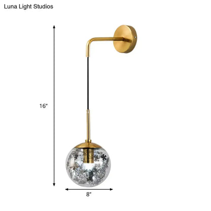 Modern gold-toned wall sconce with clear glass shattered leaf globe light fixture for bedroom lighting