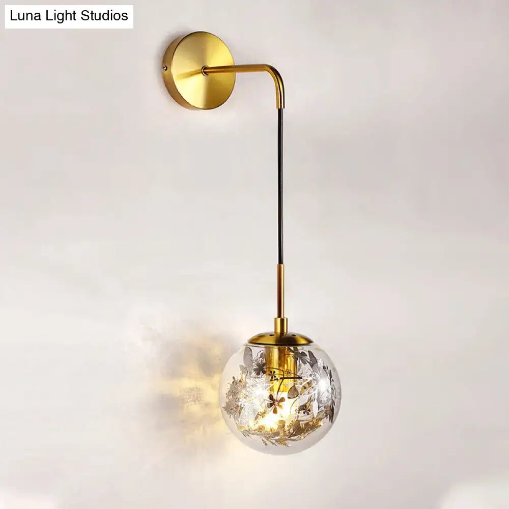 Modern gold shattered leaf clear glass globe sconce with floral etchings and black stem for bedroom light fixture