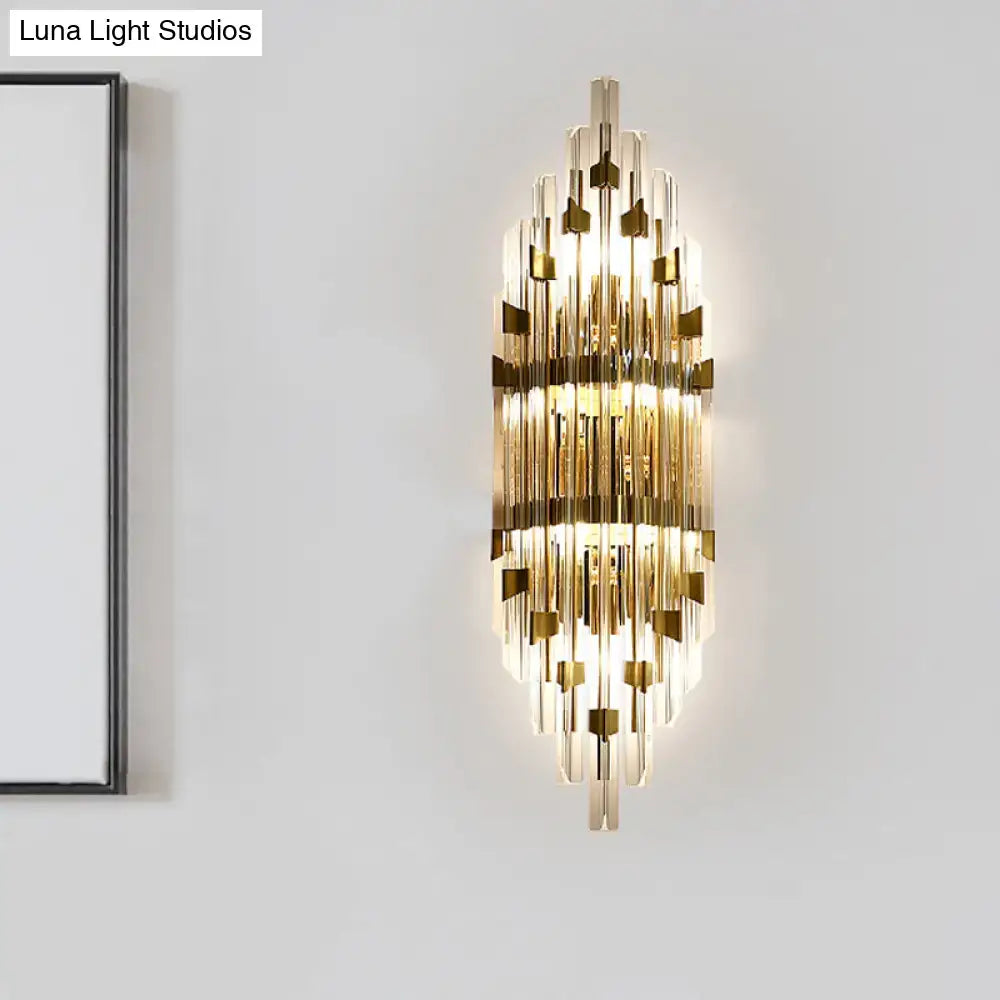 Modern gold shield 3-light wall sconce with vertical crystal rods and metallic accents for living room lighting