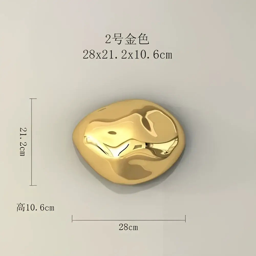 A smooth irregular golden metallic 3d stone wall ornament with polished surface for modern living room decor