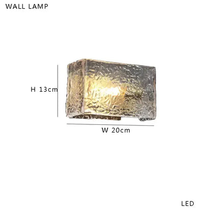 Modern gold and silver decorbites amber glass table lamp with rectangular textured translucent glass housing and warm led light