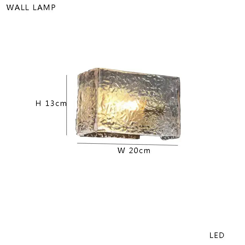 Modern gold and silver decorbites amber glass table lamp with rectangular textured translucent glass housing and warm led light