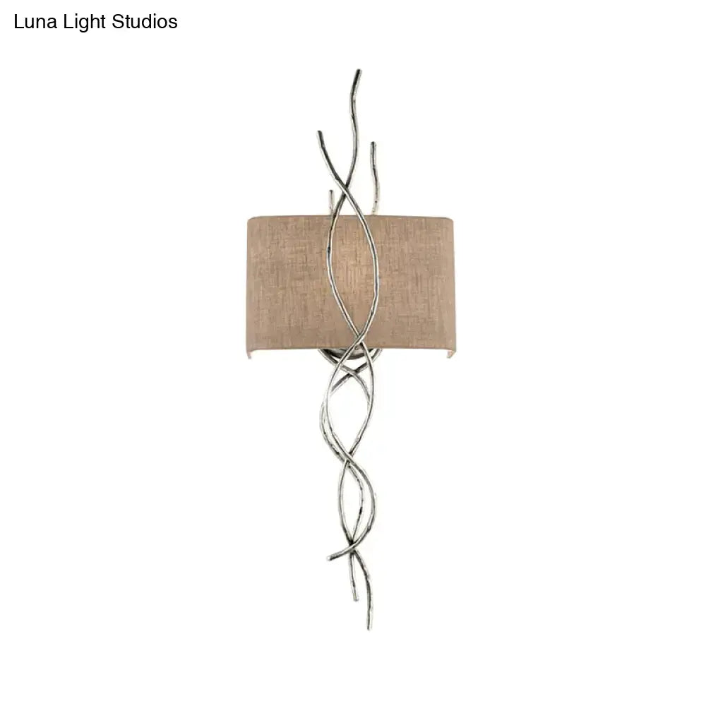 Silver twisted wire wall mount light with beige fabric shade in modern gold silver branch bedroom sconce design