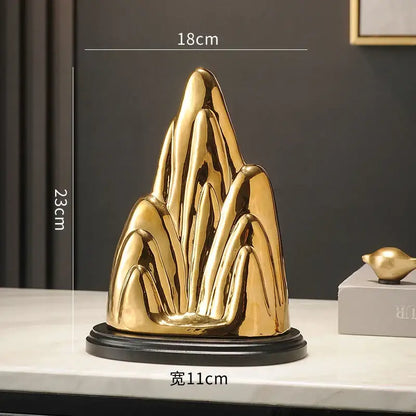Modern gold and silver ceramic mountain sculpture with sleek abstract peaks and glossy finish for living room decorbites ceramic mountain decor