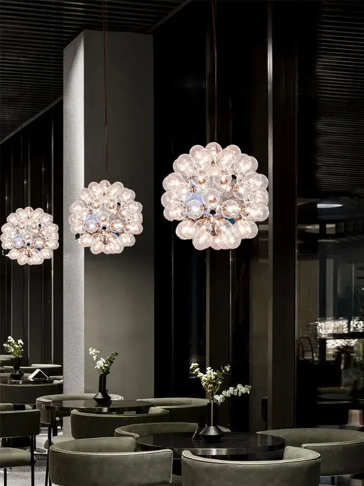 Modern gold and silver clear glass bubble chandelier with spherical orbs creating an elegant dining room light