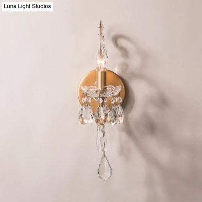 Modern gold and silver crystal drop sconce light with clear crystal droplets and faceted prisms for living room decor