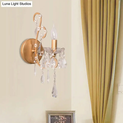 Modern gold and silver sconce light with clear crystal drop accents for elegant living room decor