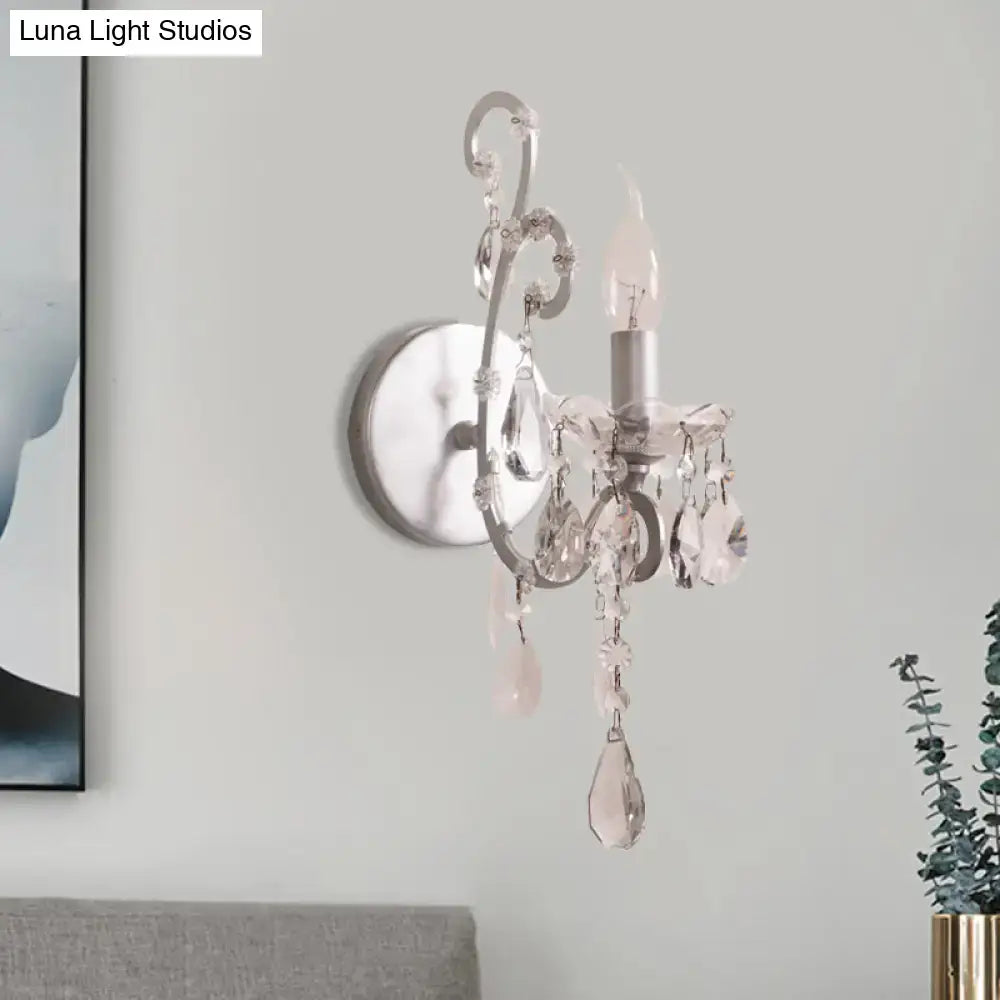 Elegant sconce light with silver gold crystal drop design and dangling faceted crystals for modern living room decor