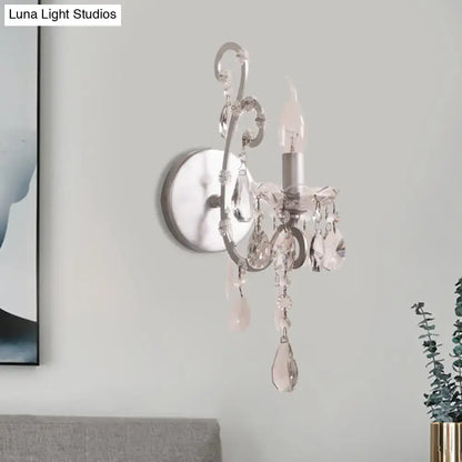 Elegant sconce light with silver gold crystal drop design and dangling faceted crystals for modern living room decor