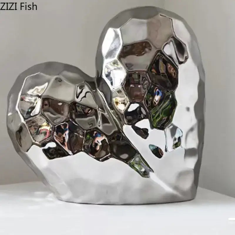 Shiny silver heart-shaped ceramic statue with faceted honeycomb surface for modern home decor decorbites golden heart