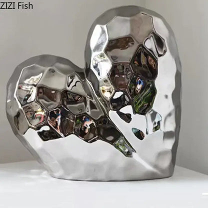 Shiny silver heart-shaped ceramic statue with faceted honeycomb surface for modern home decor decorbites golden heart