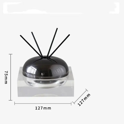 Black spherical aromatherapy diffuser with clear glass base and four black reeds from decorbites golden geometry collection