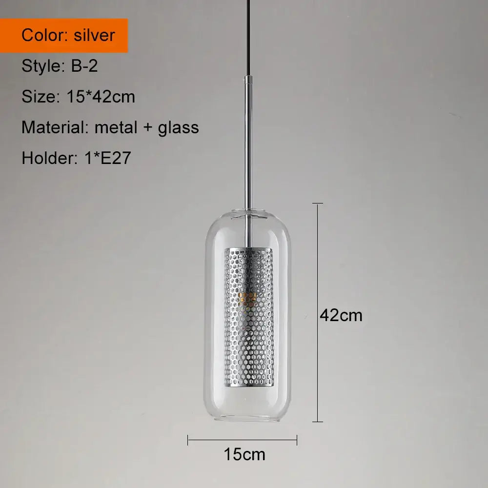 Modern gold and silver pendant light with cylindrical glass enclosure and perforated metal center for kitchen use