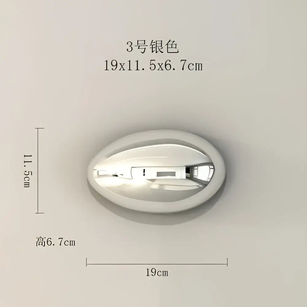 Silver oval-shaped wall mounted light fixture with sleek metallic finish for modern gold and silver wall hanging ornaments
