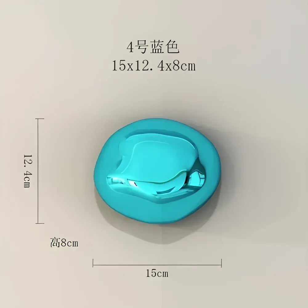 A vibrant turquoise glossy oval button with smooth reflective surface featured in modern metallic wall hanging ornaments