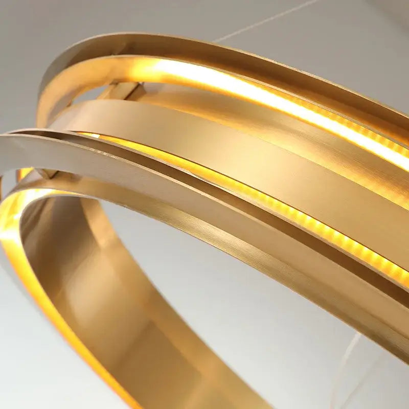 Modern gold and silver ring chandelier with sleek curved bands for living room decorbites gold ring pendant light