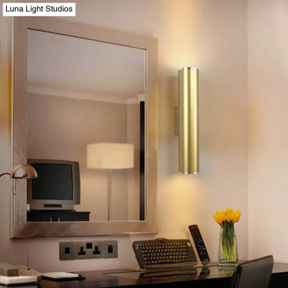 Gold tube wall mounted cylindrical sconce with a sleek modern design for corridor lighting in gold finish