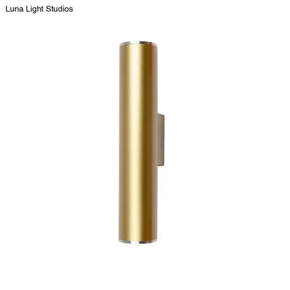 Gold tube wall mounted cylindrical sconce with a sleek minimalist design and brushed metal accents for corridor lighting