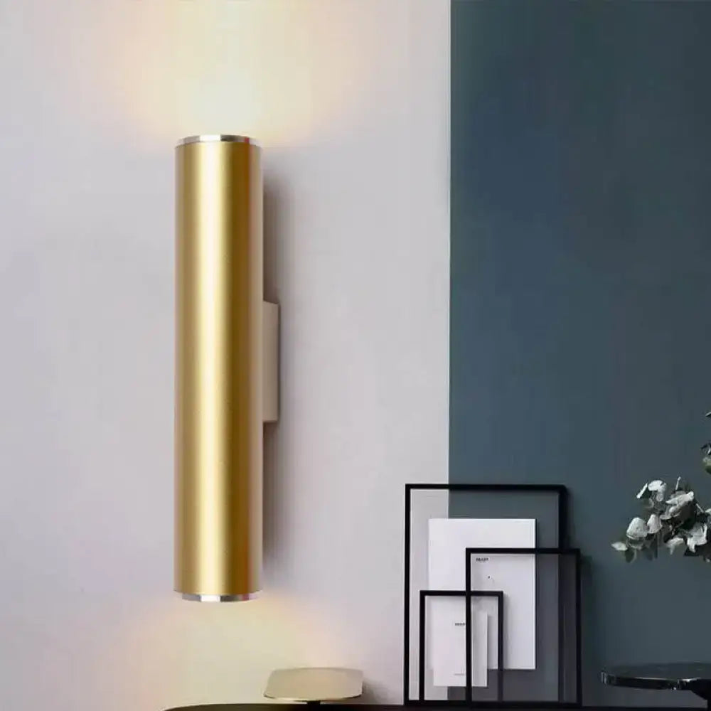 Modern gold tube wall mounted cylindrical sconce with a gold finish and sleek design for corridor lighting
