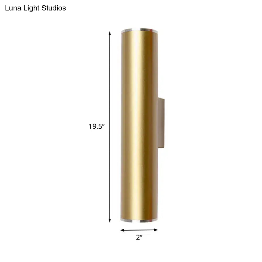 A sleek 19.5 inch tall brushed gold tube wall mounted sconce with polished silver accents for corridor lighting