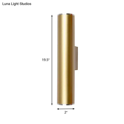 A sleek 19.5 inch tall brushed gold tube wall mounted sconce with polished silver accents for corridor lighting