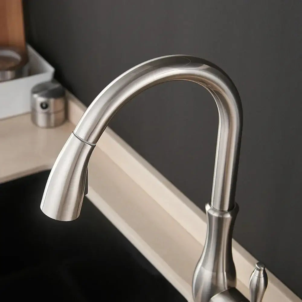 Modern gold single handle pull out kitchen faucet with a sleek curved spout and polished stainless steel finish