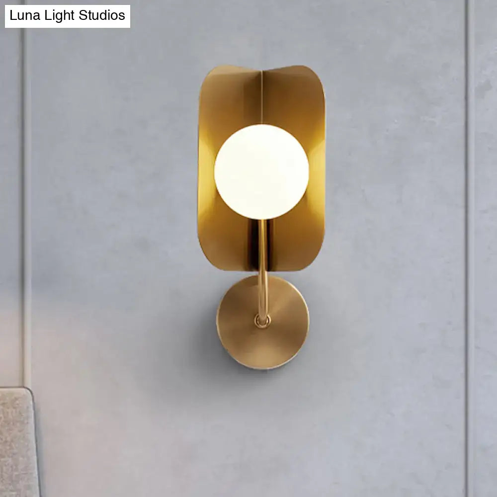 Modern gold sphere metal wall light with led bulb featuring a minimalist leaf-shaped metal wall sconce and frosted glass bulb