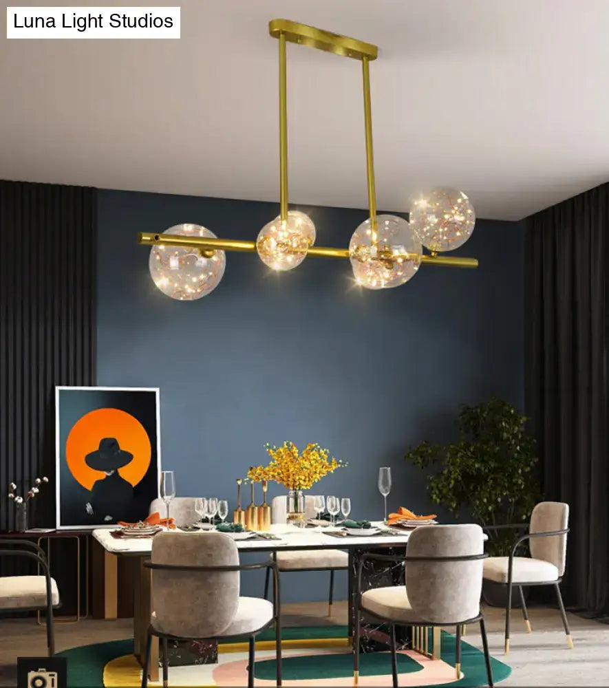 Modern gold spherical clear glass chandelier light fixture with five clear glass globes and warm led lights for dining room