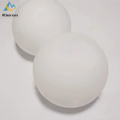 Two smooth matte white ping pong balls with subtle texture featured alongside modern gold frosted glass led wall lamps